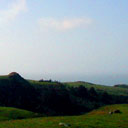 green sloping hills against blue sky